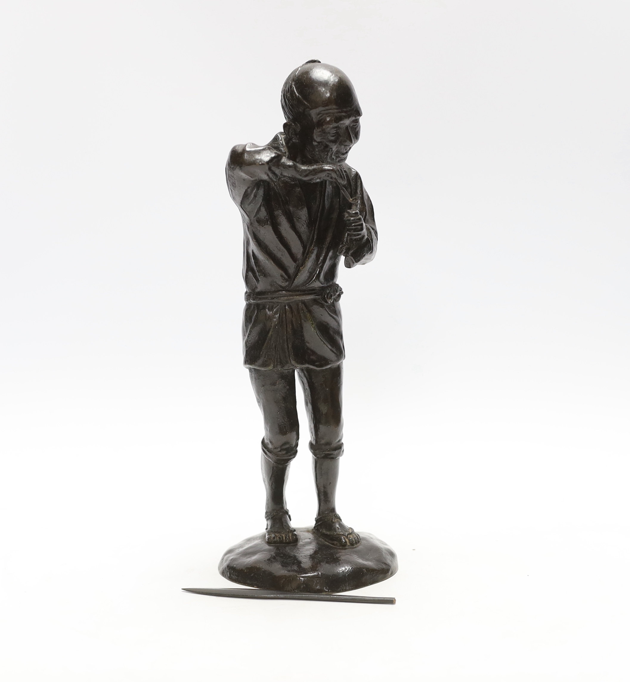 A Japanese Meiji period bronze of a pipe smoker, 29cm high